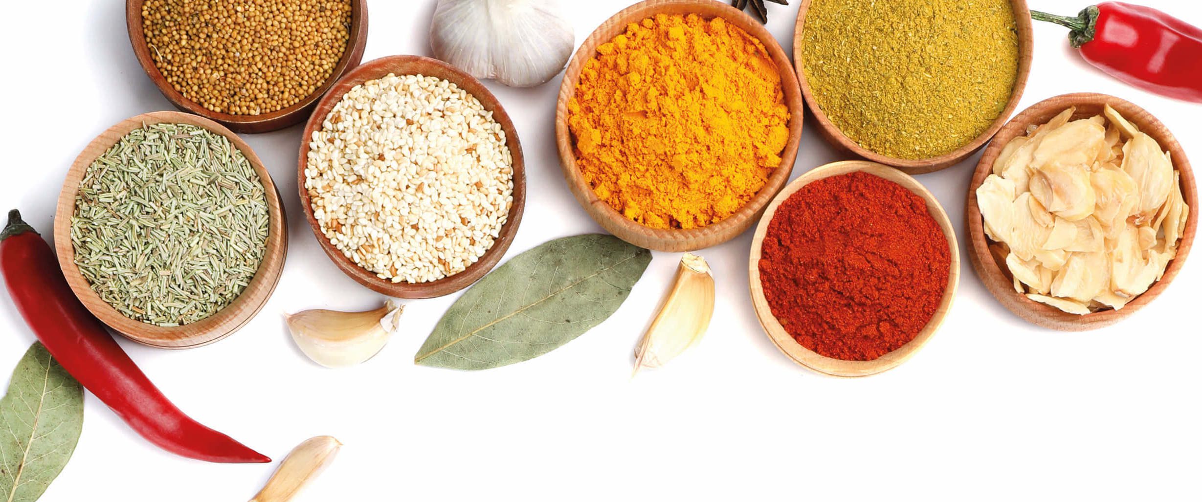 A variety of spices in bowls on a white background, exploring the mouth's receptor for taste.